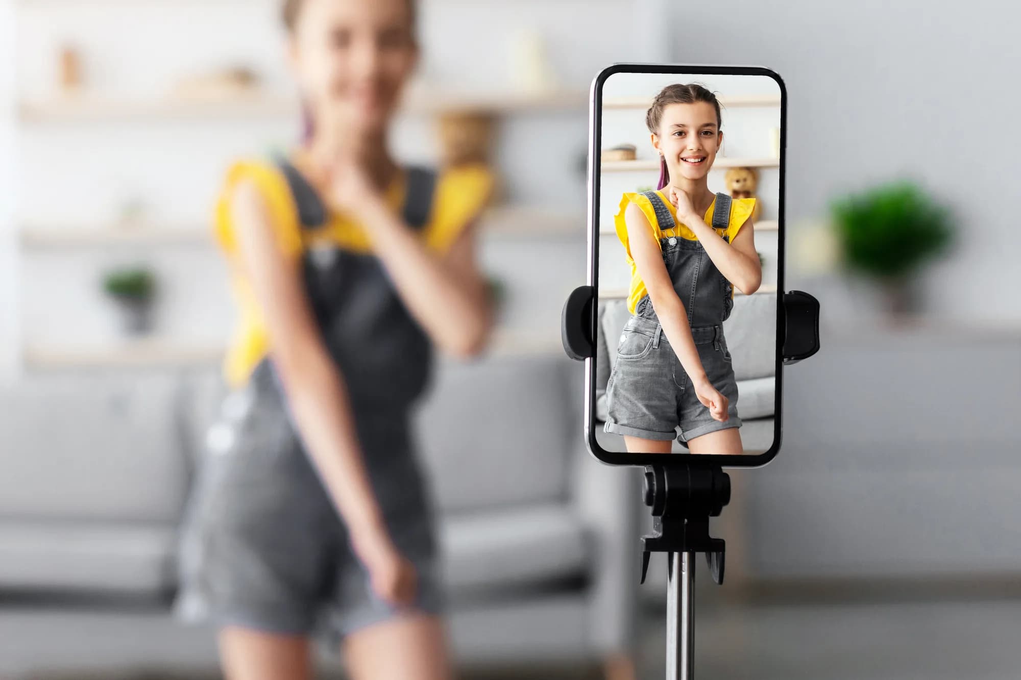 A content creator recording a video on a tripod-mounted smartphone