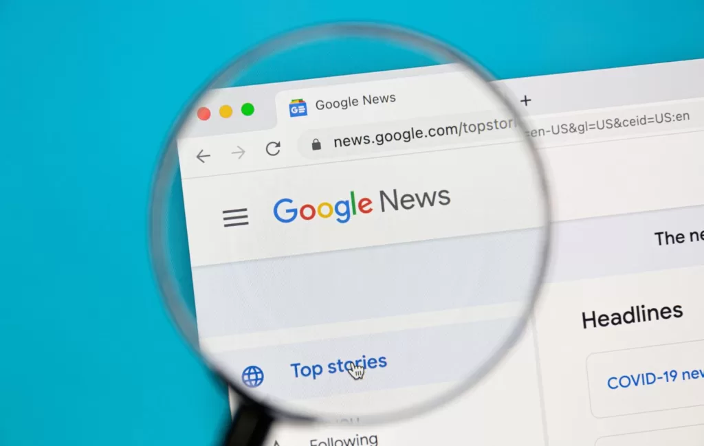 A magnifying glass over the Google News search page