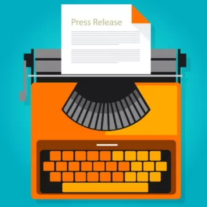 Image of an orange typewriter with a paper titled Press Release" on the top